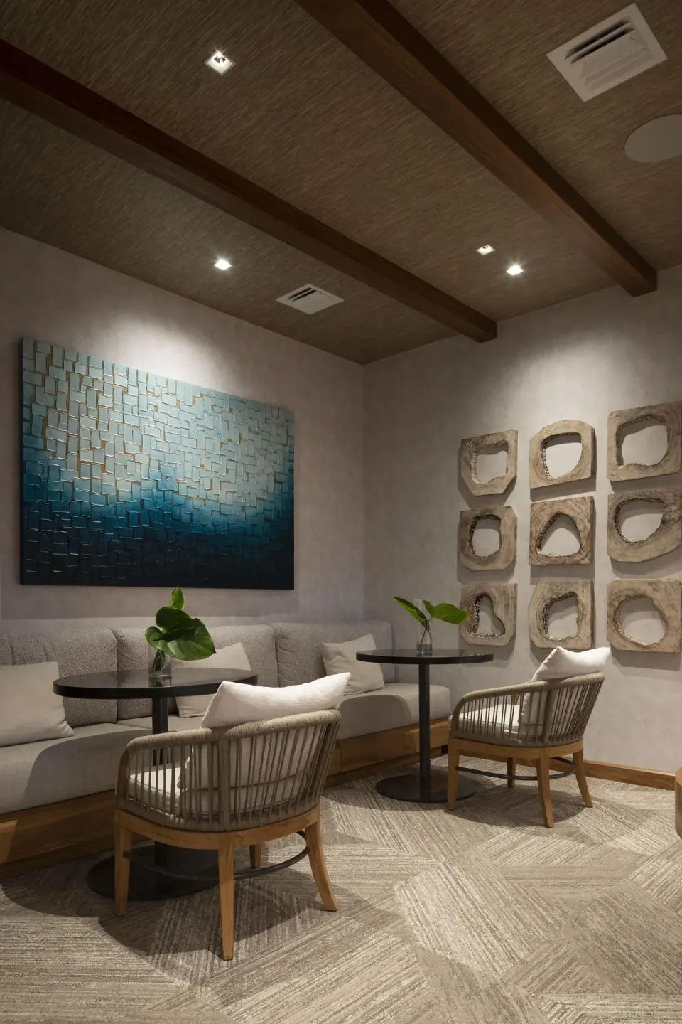 Quiet lounge nook with cushioned seating and wall art at 'Alohilani Resort Waikiki Beach.