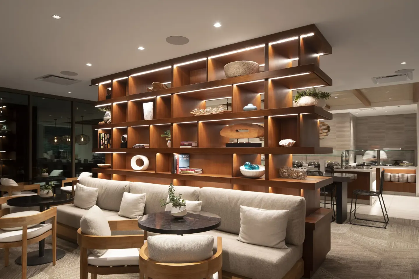 Lounge seating and illuminated display shelves at 'Alohilani Resort Waikiki Beach.