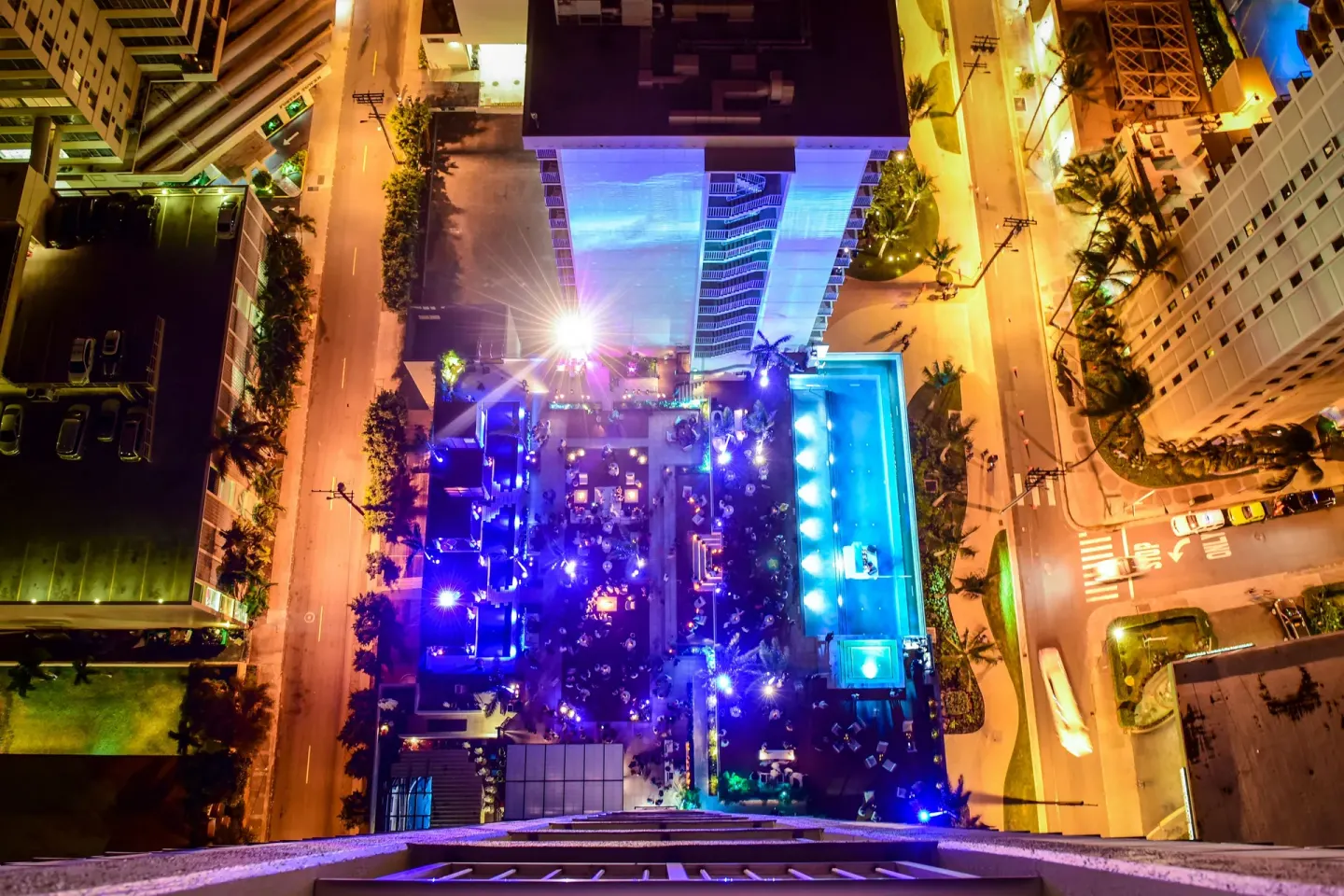 Aerial night view of the pool deck and city streets at 'Alohilani Resort Waikiki Beach.