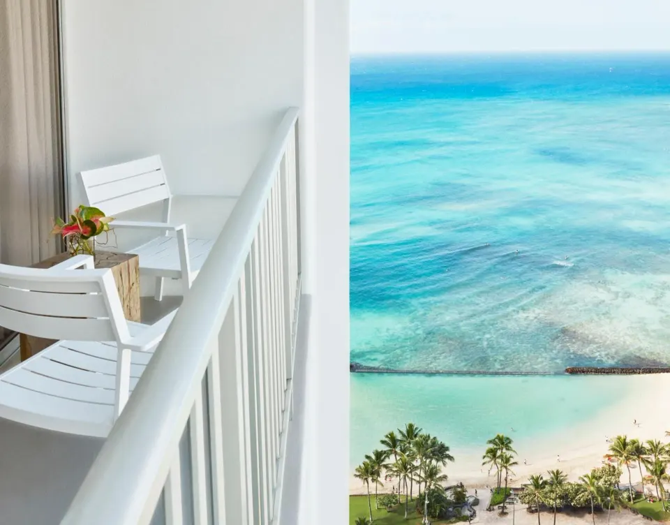 Guest room balcony with chairs and Waikiki ocean view at 'Alohilani Resort Waikiki Beach.