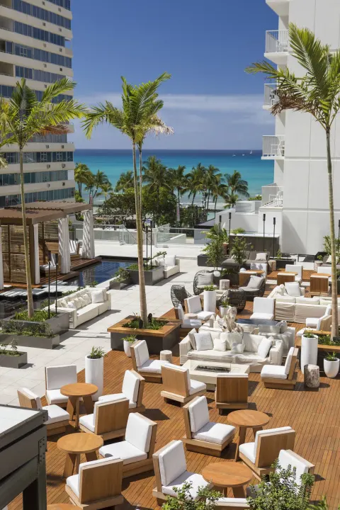 Pool terrace lounge seating with ocean backdrop at 'Alohilani Resort Waikiki Beach.