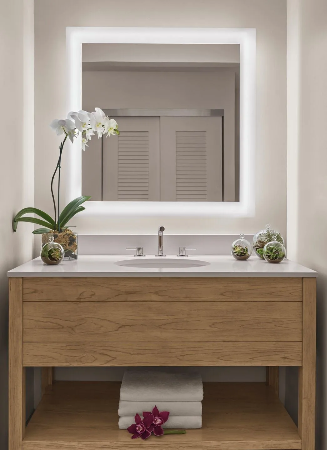 Classic Room bathroom vanity with backlit mirror at 'Alohilani Resort Waikiki Beach.