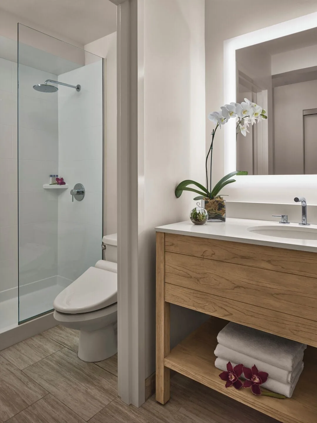 Classic Room bathroom vanity and glass shower at 'Alohilani Resort Waikiki Beach.