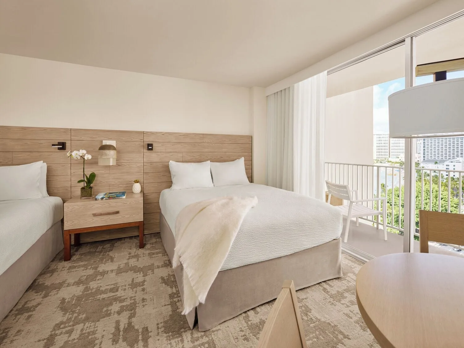 Classic Room two beds with balcony seating at 'Alohilani Resort Waikiki Beach.
