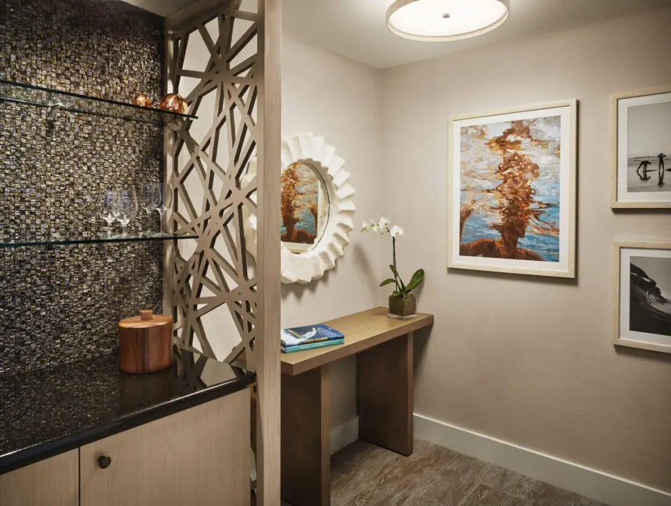 Entry nook with bar shelves and artwork in a Premier Ocean Front room at 'Alohilani Resort Waikiki Beach.
