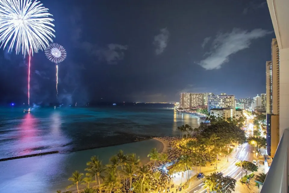Fireworks over Waikiki Beach and the ocean from a Premier Ocean Front room at 'Alohilani Resort Waikiki Beach.