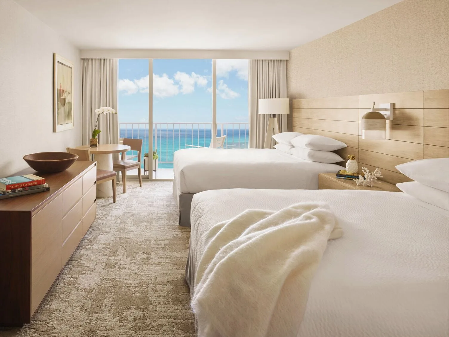Premier Oceanfront guest room with two beds and ocean-facing balcony at 'Alohilani Resort Waikiki Beach.