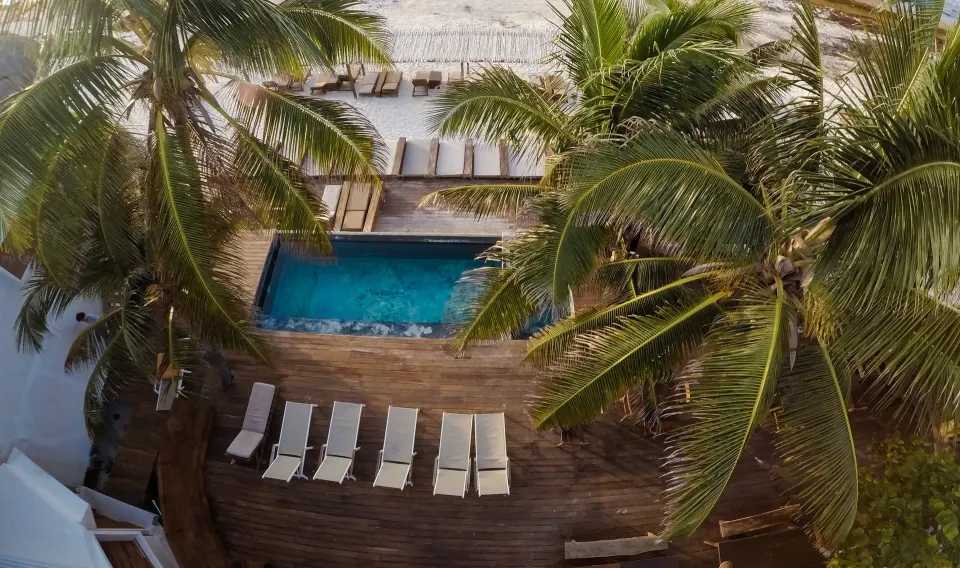Overhead view of a rectangular pool and sun loungers at Amansala