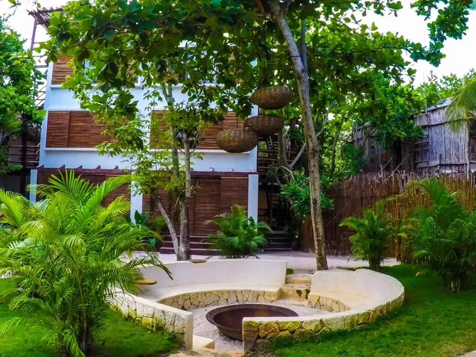 Sunken stone firepit and hanging lanterns in a garden courtyard at Amansala