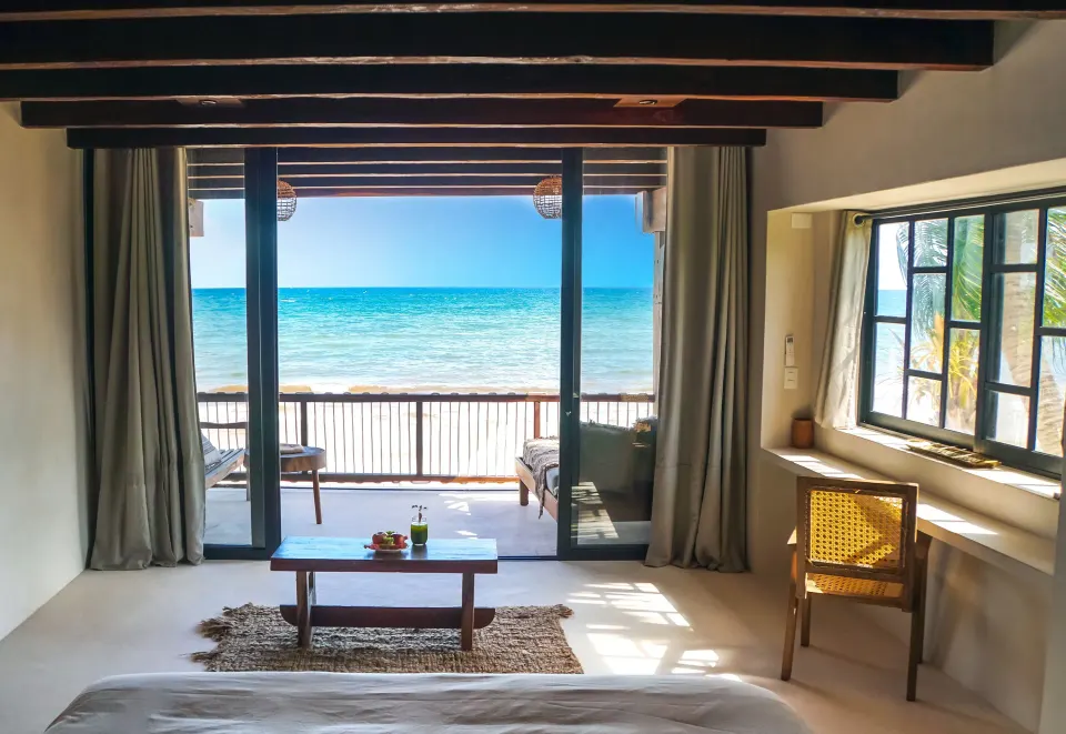 Sea-facing suite with sliding glass doors and balcony at Amansala