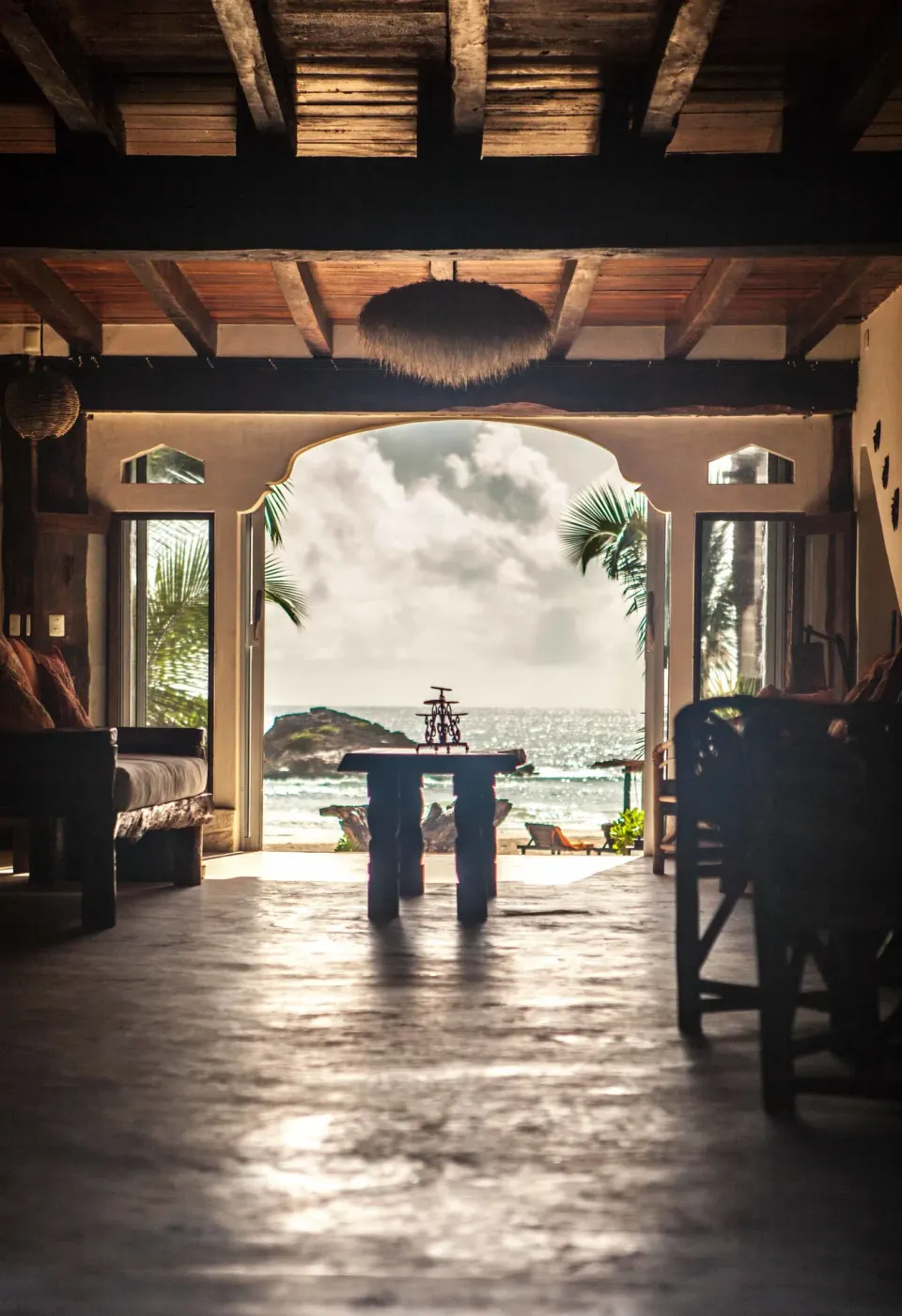 Open lounge framing the ocean view through an arched opening at Amansala