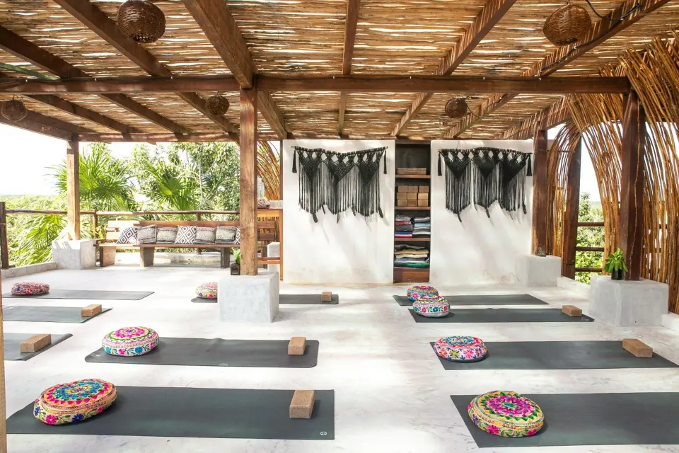 Yoga mats laid out on a covered open-air studio at Amansala
