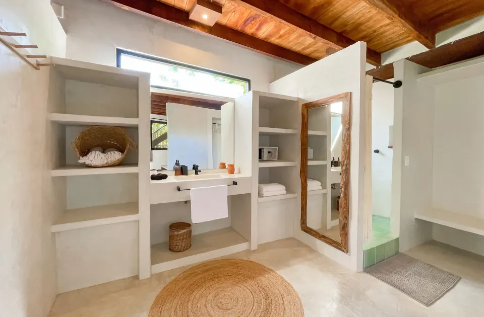 Bright open bathroom and shelving in a suite at Amansala