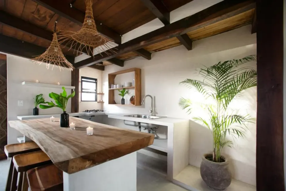 Kitchen island and breakfast bar with pendant lights at Amansala