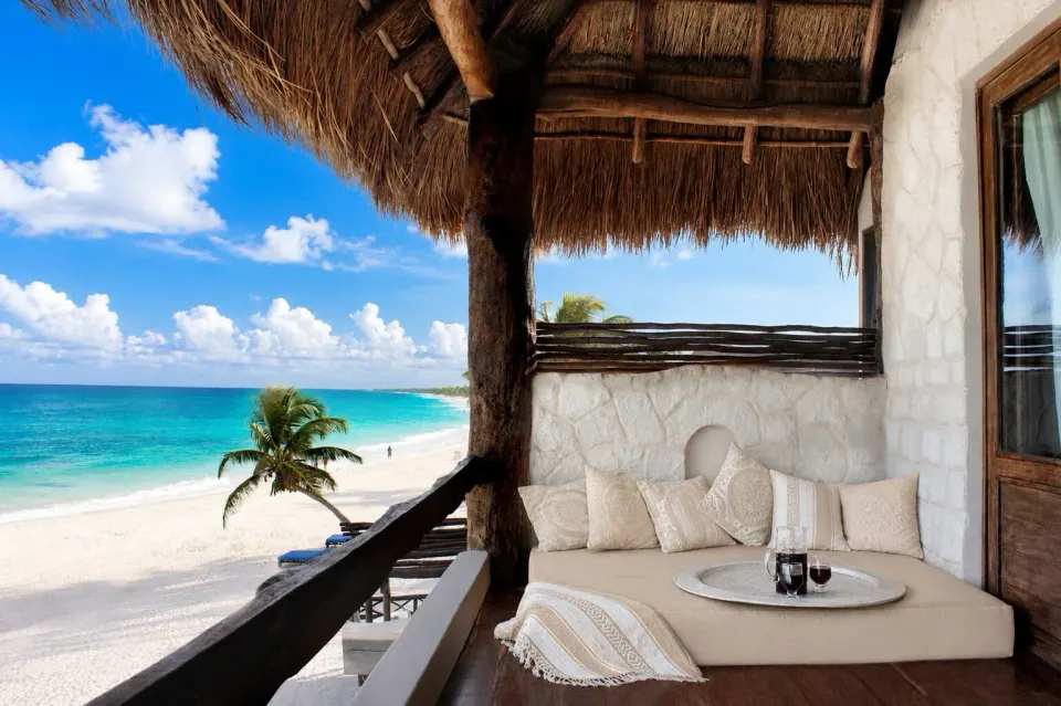 Private balcony lounge overlooking the beach and turquoise sea at Amansala
