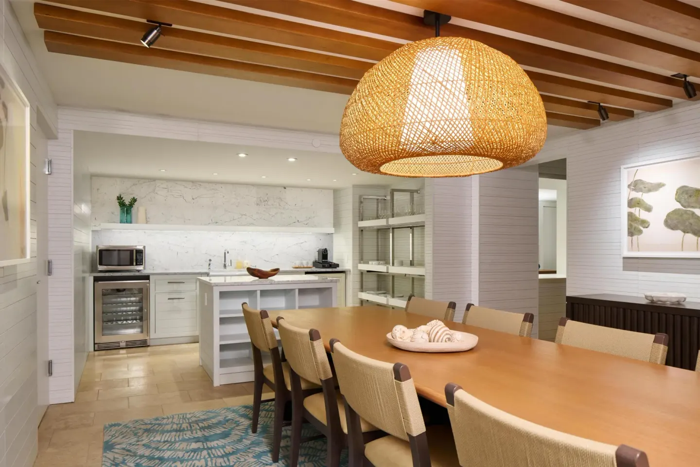 Dining room and kitchenette with wood table at Andaz Maui at Wailea Resort.