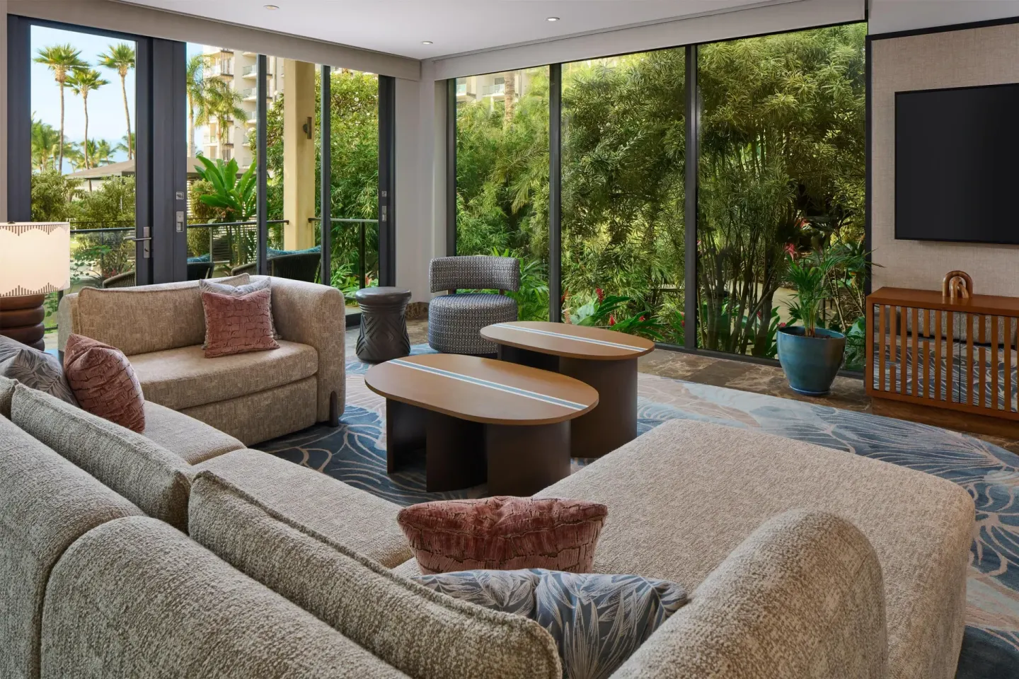 Garden-level living room with large windows at Andaz Maui at Wailea Resort.
