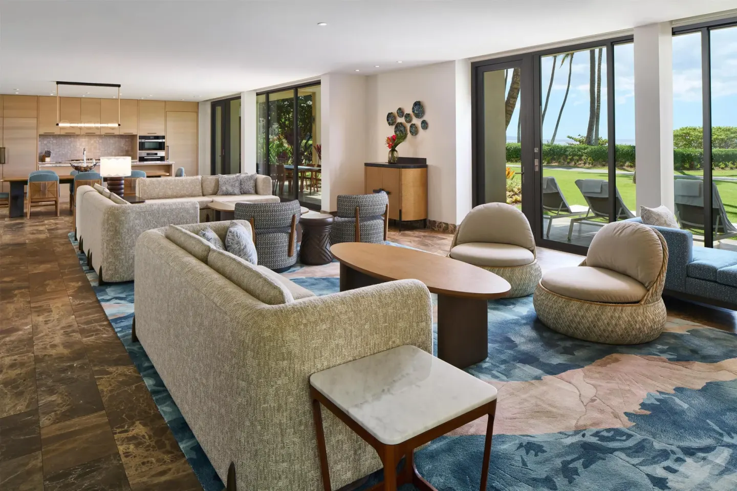 Large suite lounge with kitchen and lawn-view glass doors at Andaz Maui at Wailea Resort.