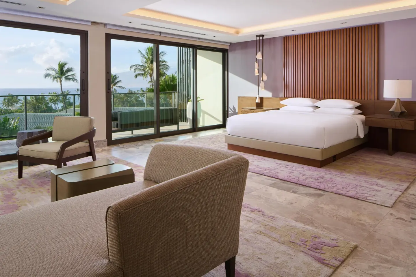 Spacious king guest room with seating and ocean-facing balcony at Andaz Maui at Wailea Resort.