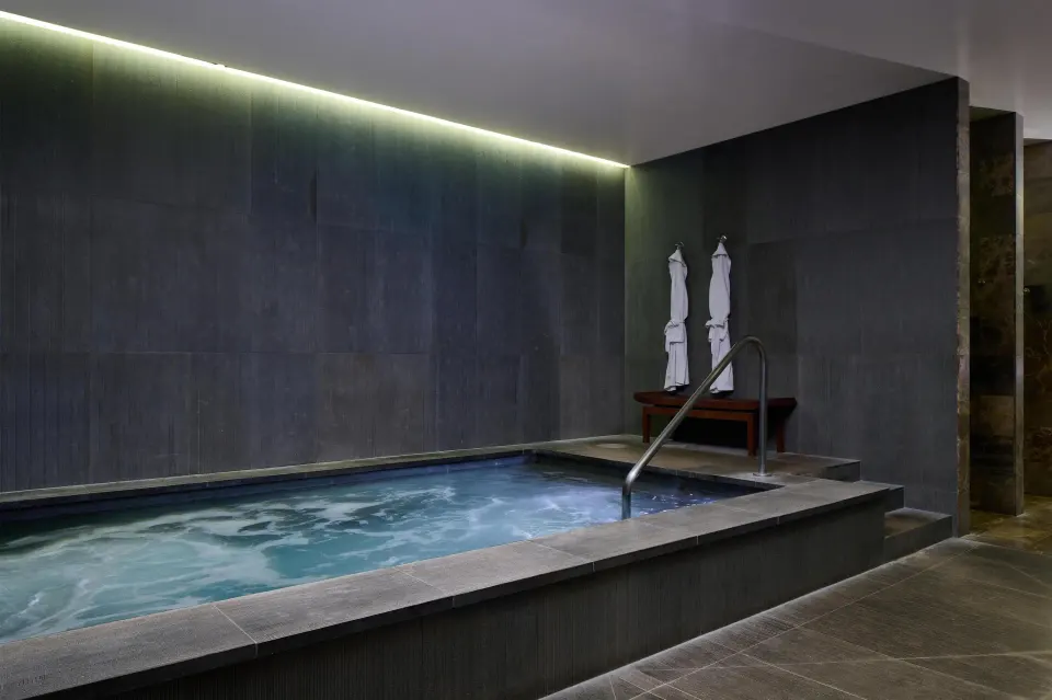 Indoor spa soaking pool with robes at Andaz Maui at Wailea Resort.