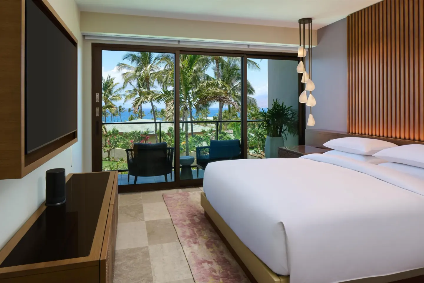 King bed guest room with balcony and palm-framed ocean view at Andaz Maui at Wailea Resort.