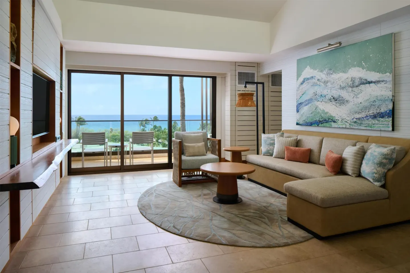 Suite living room with sectional sofa and ocean-facing balcony at Andaz Maui at Wailea Resort.