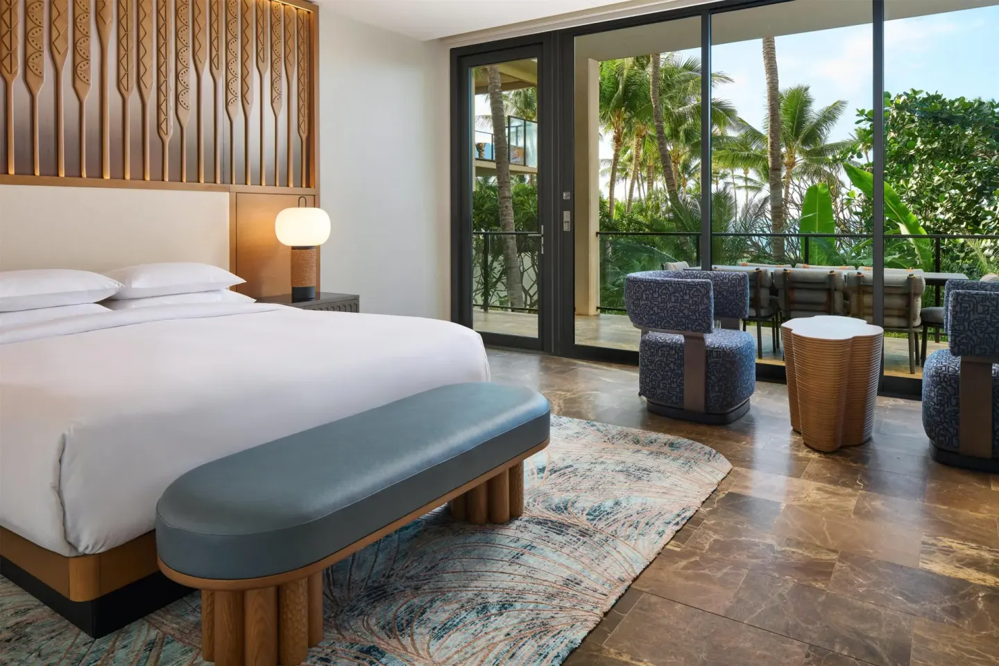 King guest room with balcony seating and palm views at Andaz Maui at Wailea Resort.