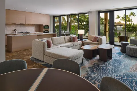 Open suite living room and kitchen with balcony doors at Andaz Maui at Wailea Resort.