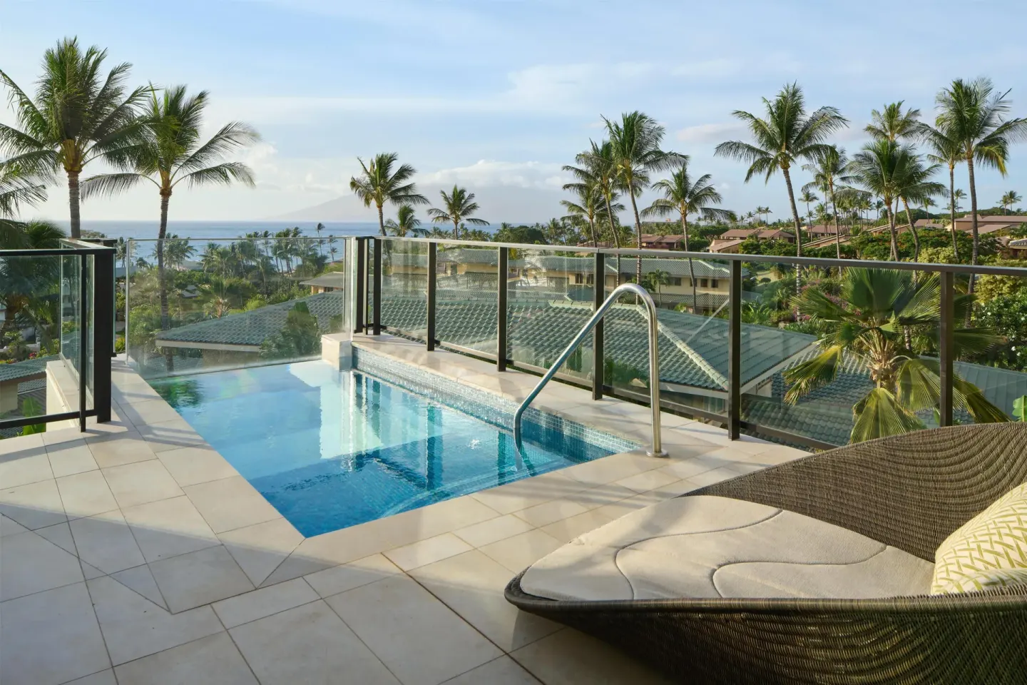 Terrace plunge pool and lounge chair with palm and ocean views at Andaz Maui at Wailea Resort.