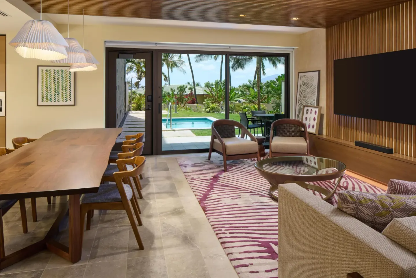 Living and dining area opening to a private pool at Andaz Maui at Wailea Resort.