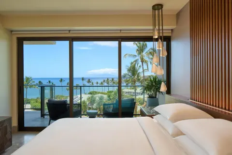 Ocean-view villa bedroom with white bedding and balcony at Andaz Maui at Wailea Resort.