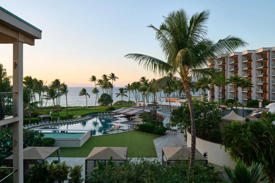 Ocean, pool, palms, and resort grounds viewed from the villa at Andaz Maui at Wailea Resort.