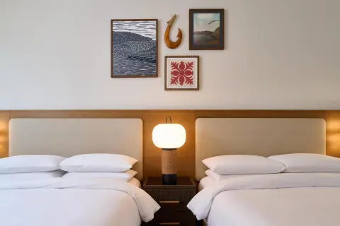 Close view of two-bed villa bedroom with island wall art at Andaz Maui at Wailea Resort.