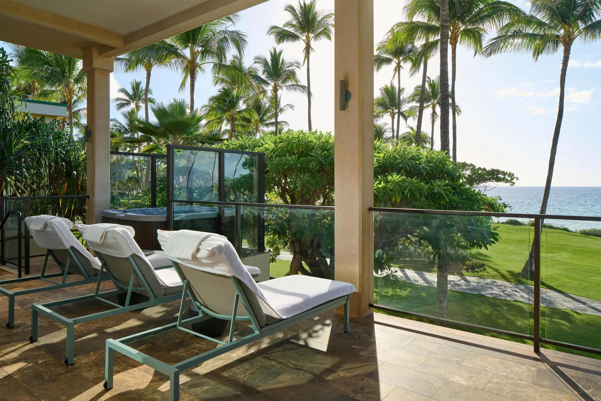 Oceanfront villa lanai with lounge chairs, spa tub, palms, and ocean view at Andaz Maui at Wailea Resort.