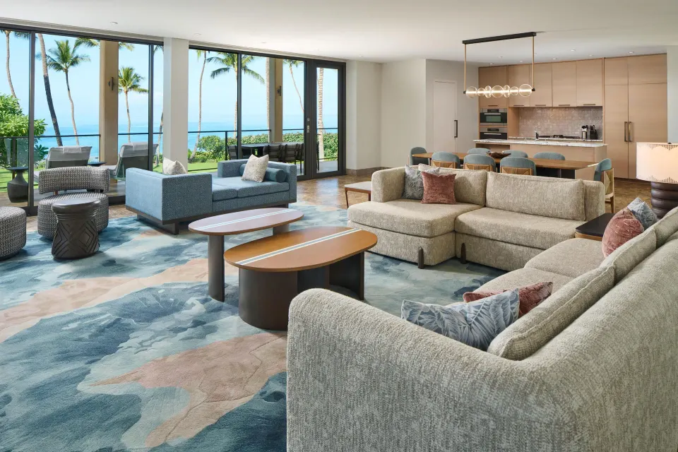 Oceanfront villa living room with sofas, kitchen, and ocean view at Andaz Maui at Wailea Resort.