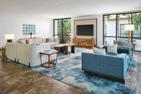Oceanfront villa lounge area with sofas and wall-mounted TV at Andaz Maui at Wailea Resort.