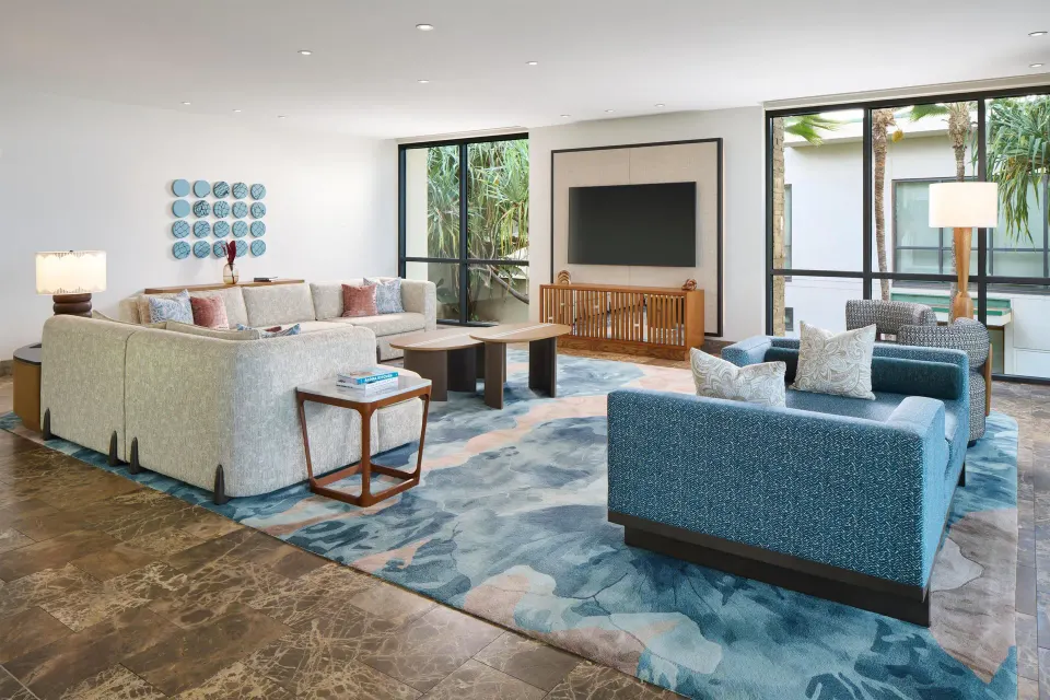 Oceanfront villa lounge area with sofas and wall-mounted TV at Andaz Maui at Wailea Resort.