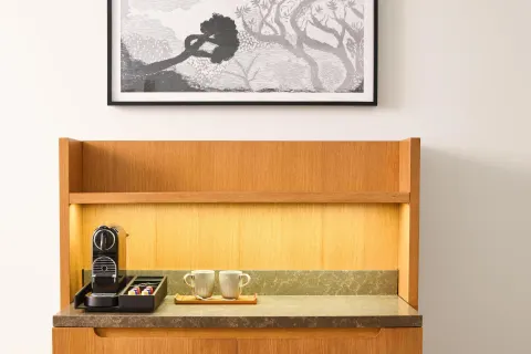 Ocean View Suite coffee station with cups and framed art at Andaz Maui at Wailea Resort.