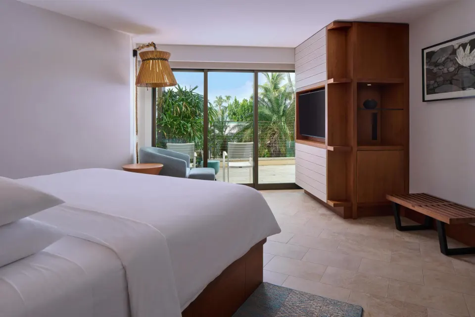 Partial View Suite bedroom with king bed and lanai at Andaz Maui at Wailea Resort.