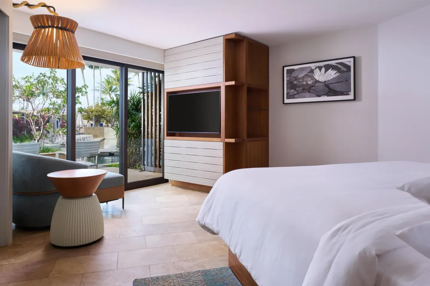 Pool Side Suite king bed and patio doors at Andaz Maui at Wailea Resort.