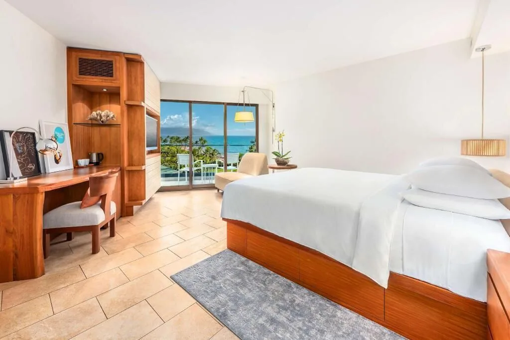 Bright ocean view accessible guest room with king bed and desk at Andaz Maui at Wailea Resort.