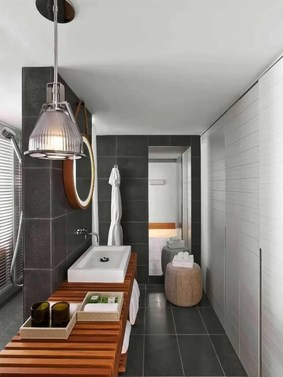 Resort View room bathroom with wood vanity and dark tile shower at Andaz Maui at Wailea Resort.