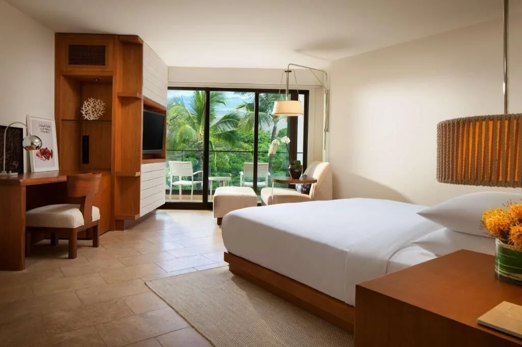 Resort View king room with balcony seating and palm trees at Andaz Maui at Wailea Resort.