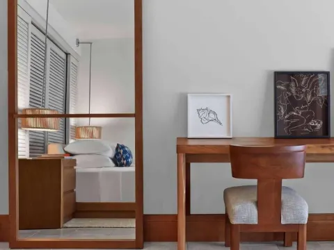 Resort View room desk and mirror reflecting the king bed at Andaz Maui at Wailea Resort.