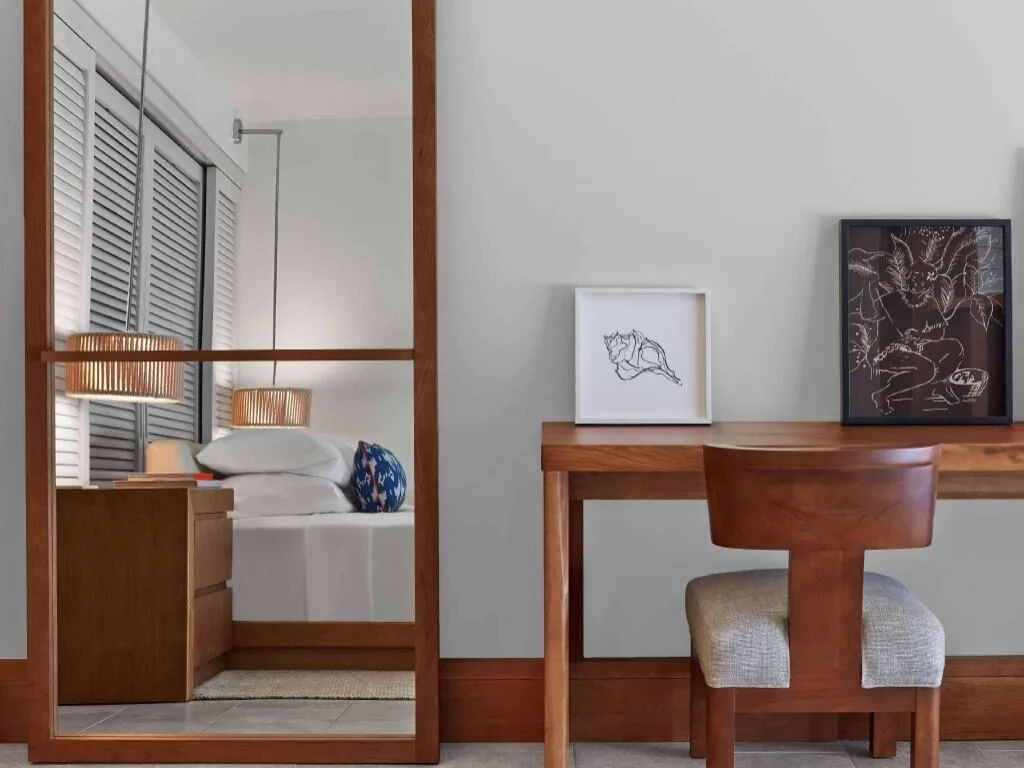 Resort View room desk and mirror reflecting the king bed at Andaz Maui at Wailea Resort.