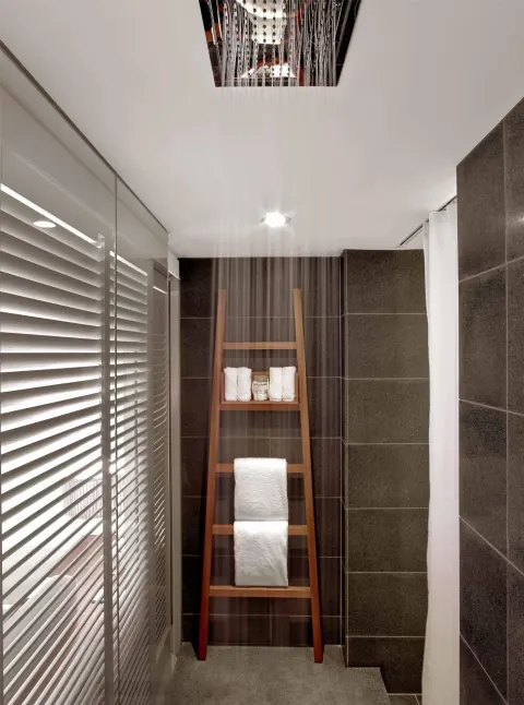 Guest room shower with rainfall water and towel ladder at Andaz Maui at Wailea Resort.