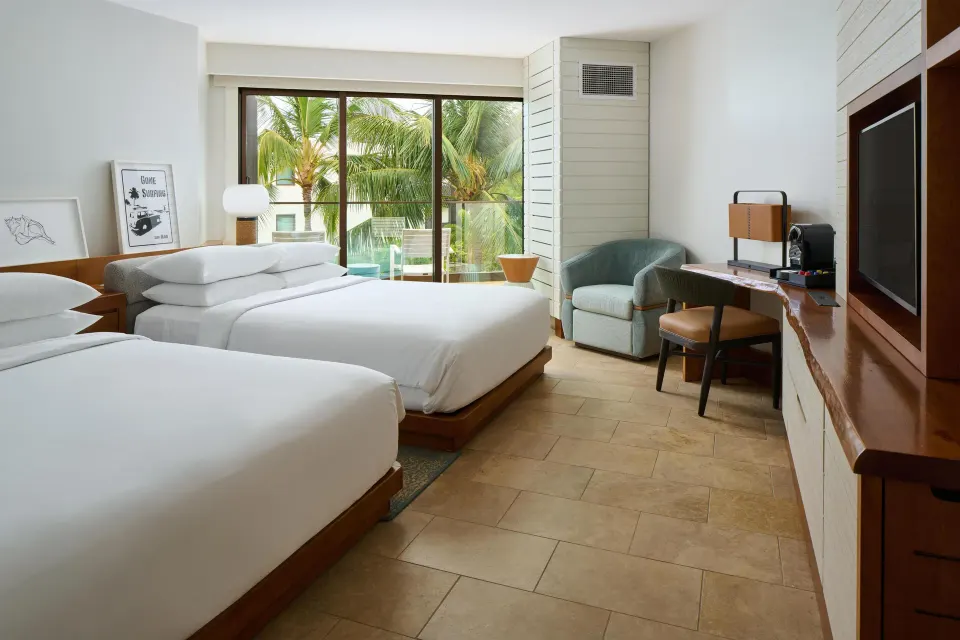 Two queen beds with balcony, palm view, desk, and TV at Andaz Maui at Wailea Resort.