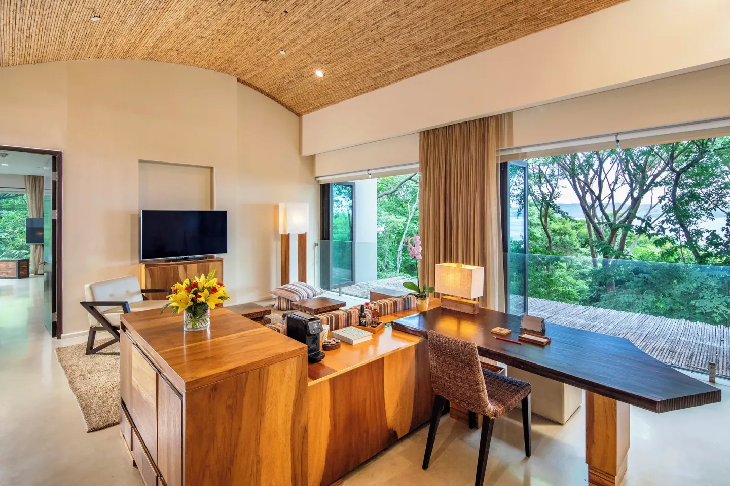 Guest room living area with desk and terrace at Andaz Peninsula Papagayo Resort, Costa Rica.