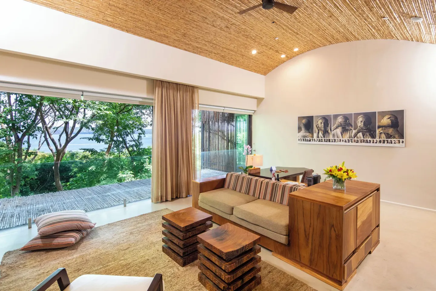 Guest room lounge with sofa and glass doors at Andaz Peninsula Papagayo Resort, Costa Rica.