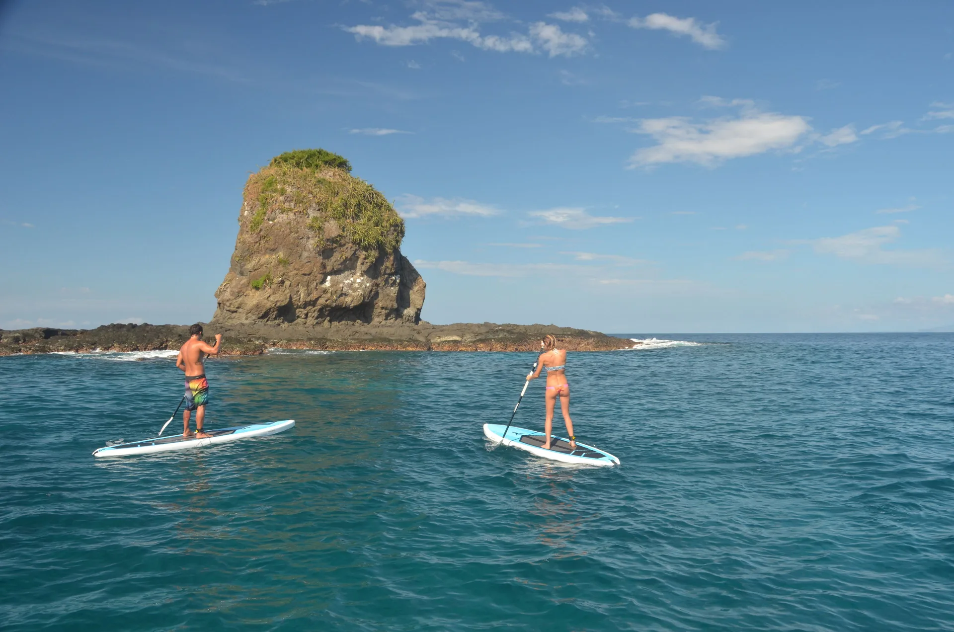 Two paddleboarders on open ocean near Andaz Peninsula Papagayo Resort, Costa Rica.